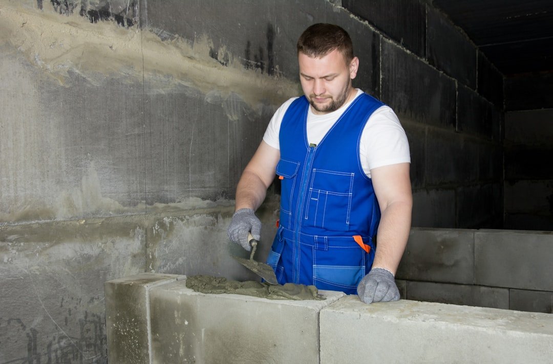With the help of a cement solution, the worker builds a wall of foam blocks. More of my photos and videos Adobe Stock:http://bit.ly/3RqlciK More of my photos and videos Shutterstock: https://www.shutterstock.com/g/ALEKSANDRBERDYUGIN My email: bermix999@gmail.com